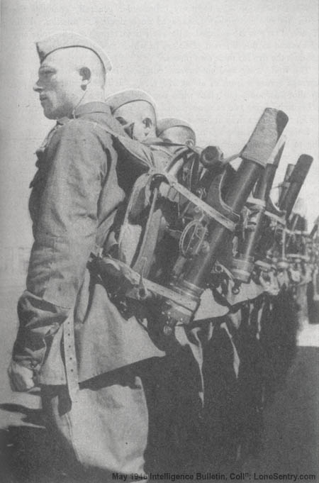 [Red Army mortarmen fall in for inspection at a Soviet training camp. The M1941 50-mm mortar, here shown in carrying position, is a weapon of the rifle company.]