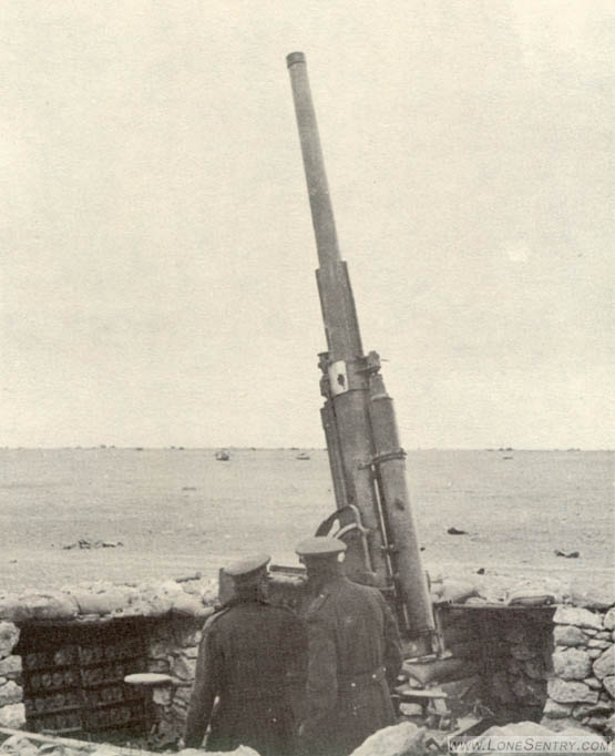 [This gun appears to be the Italian 75-mm. Ansaldo rifle in antiaircraft position. In the distance can be seen several British tanks which were destroyed in the assault on the Omar position.]